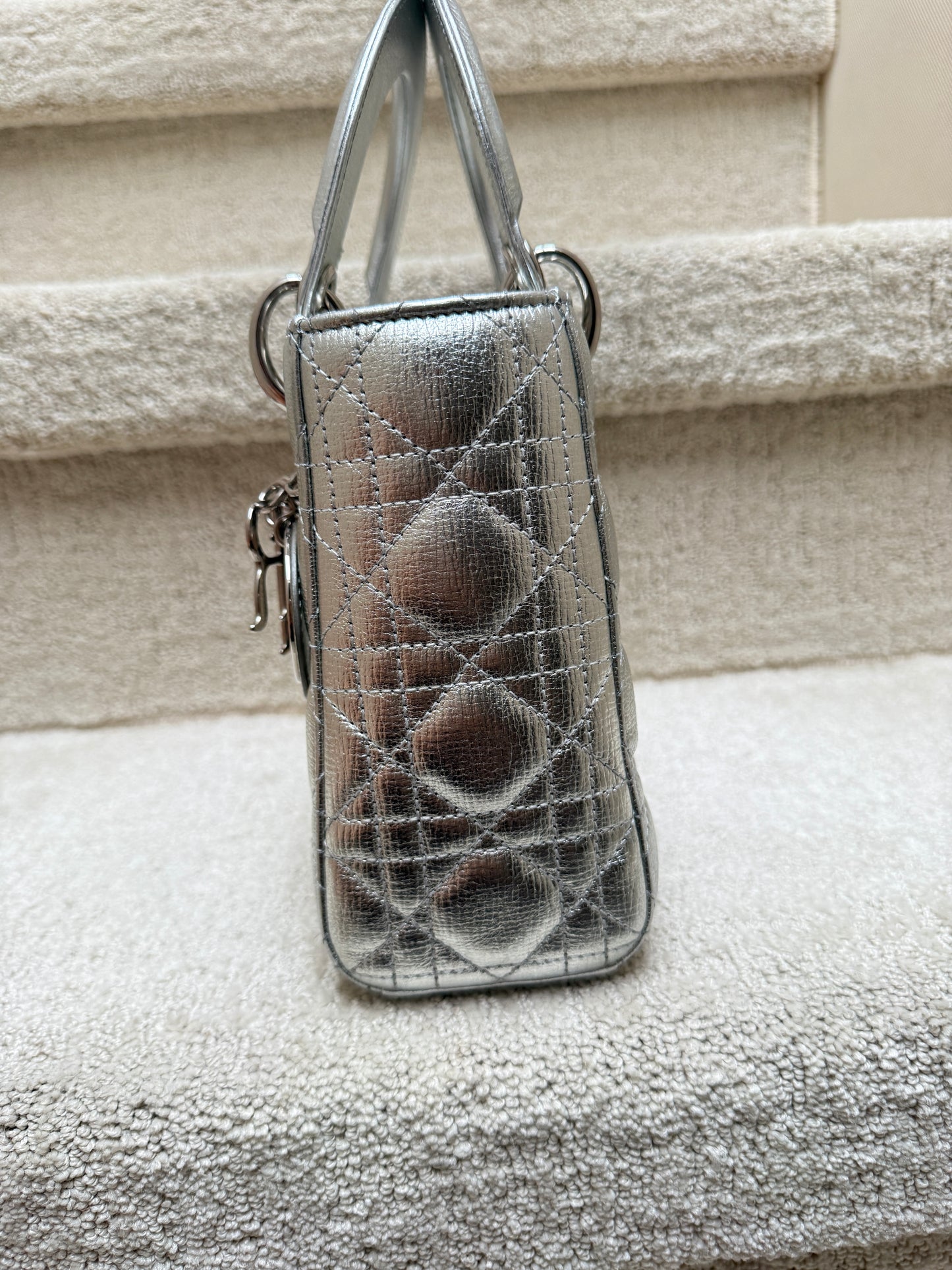 Lady Dior small handbag in silver shown in side view authentic