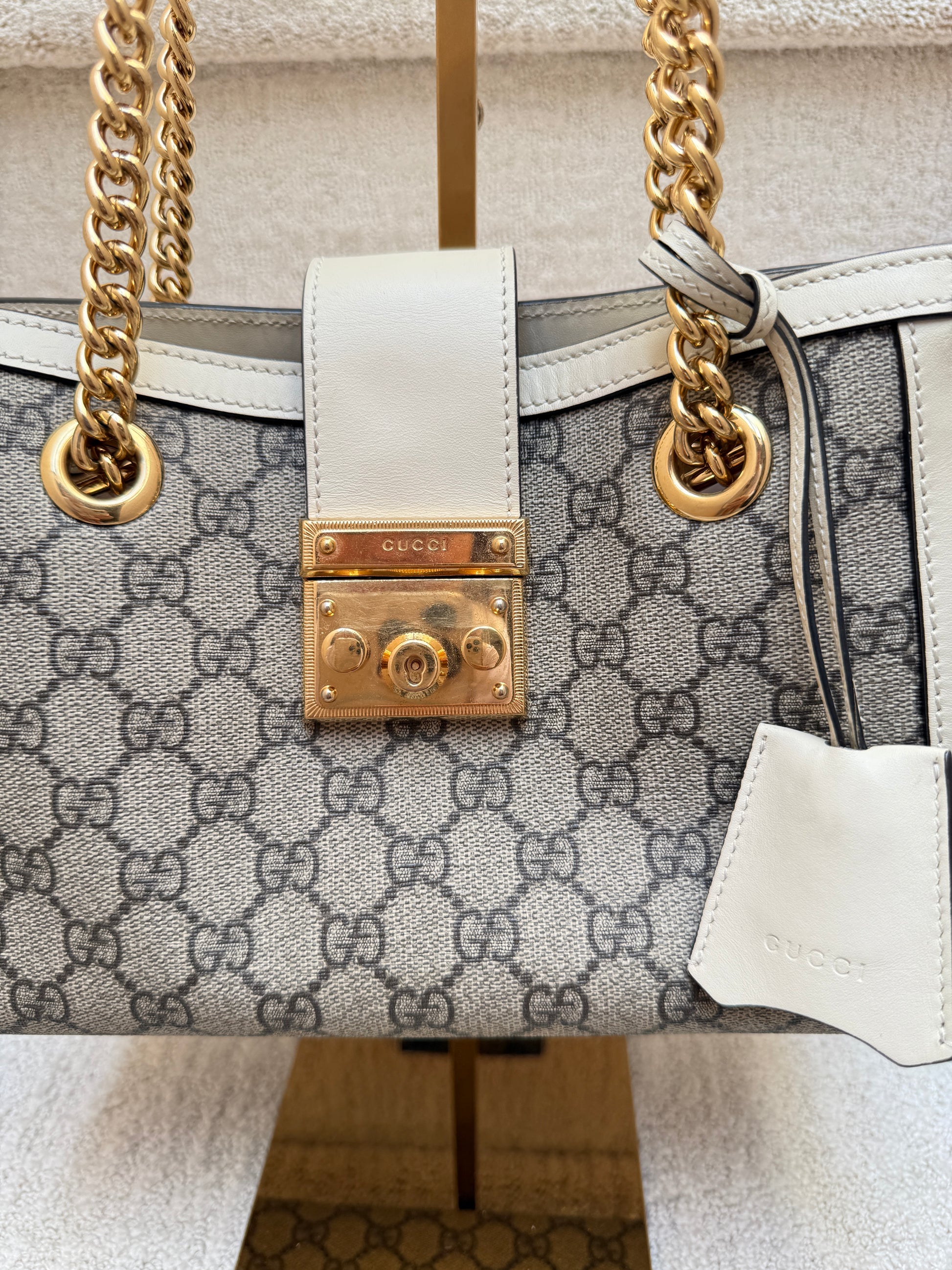 Close up of gucci padlock closure in gold hardware