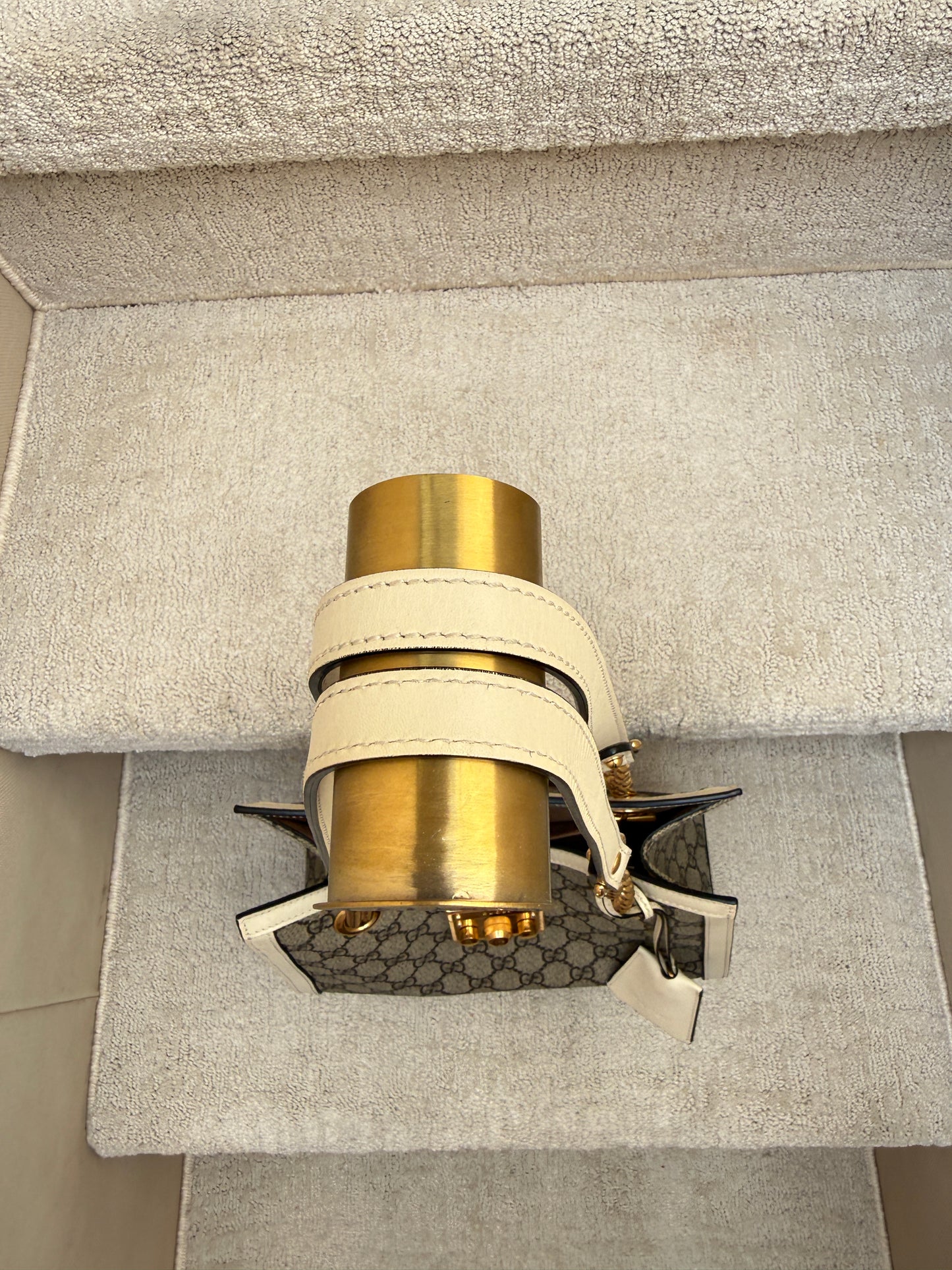 top view of handles of gucci padlock handbag white leather