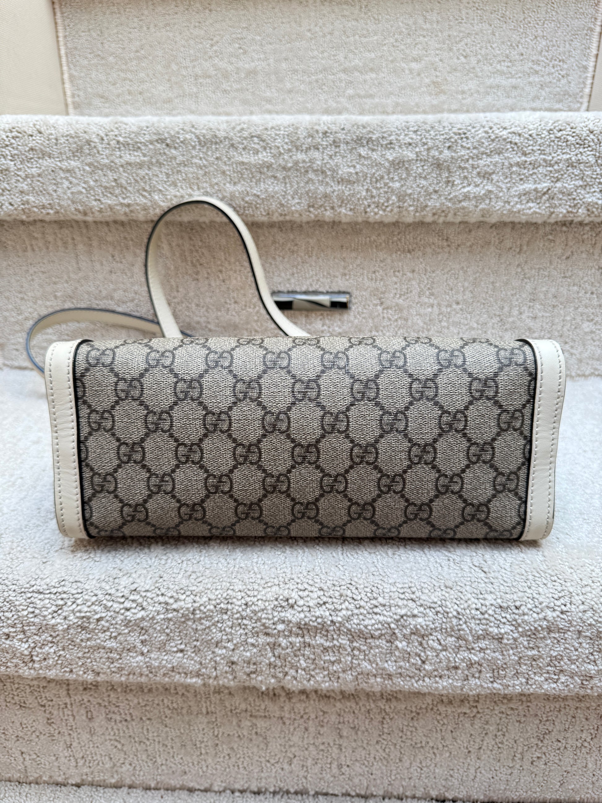 Gucci supreme handbag used in excellent condition showing bottom of handbag clean