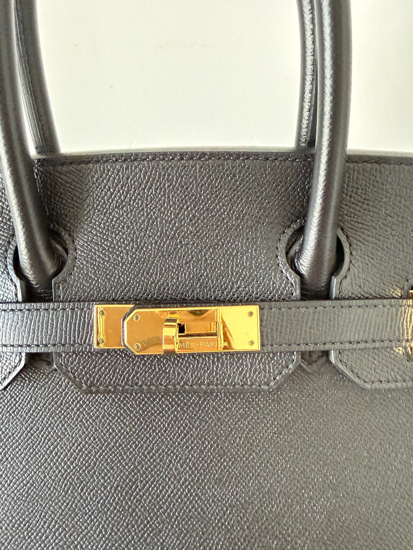 close up photo of gold turn lock hardware on hermes birkin 30 pristine used condition