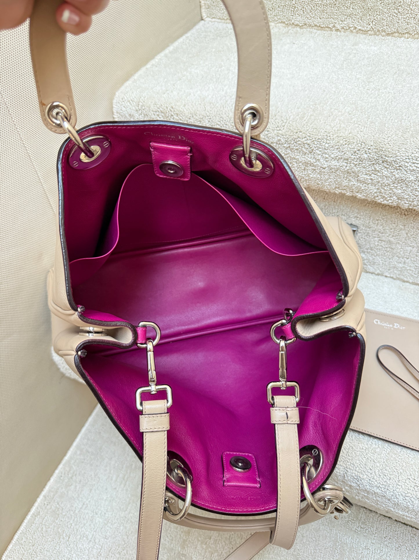Interior view of hot pink leather inside dior diorissima tote is in like new preloved condition