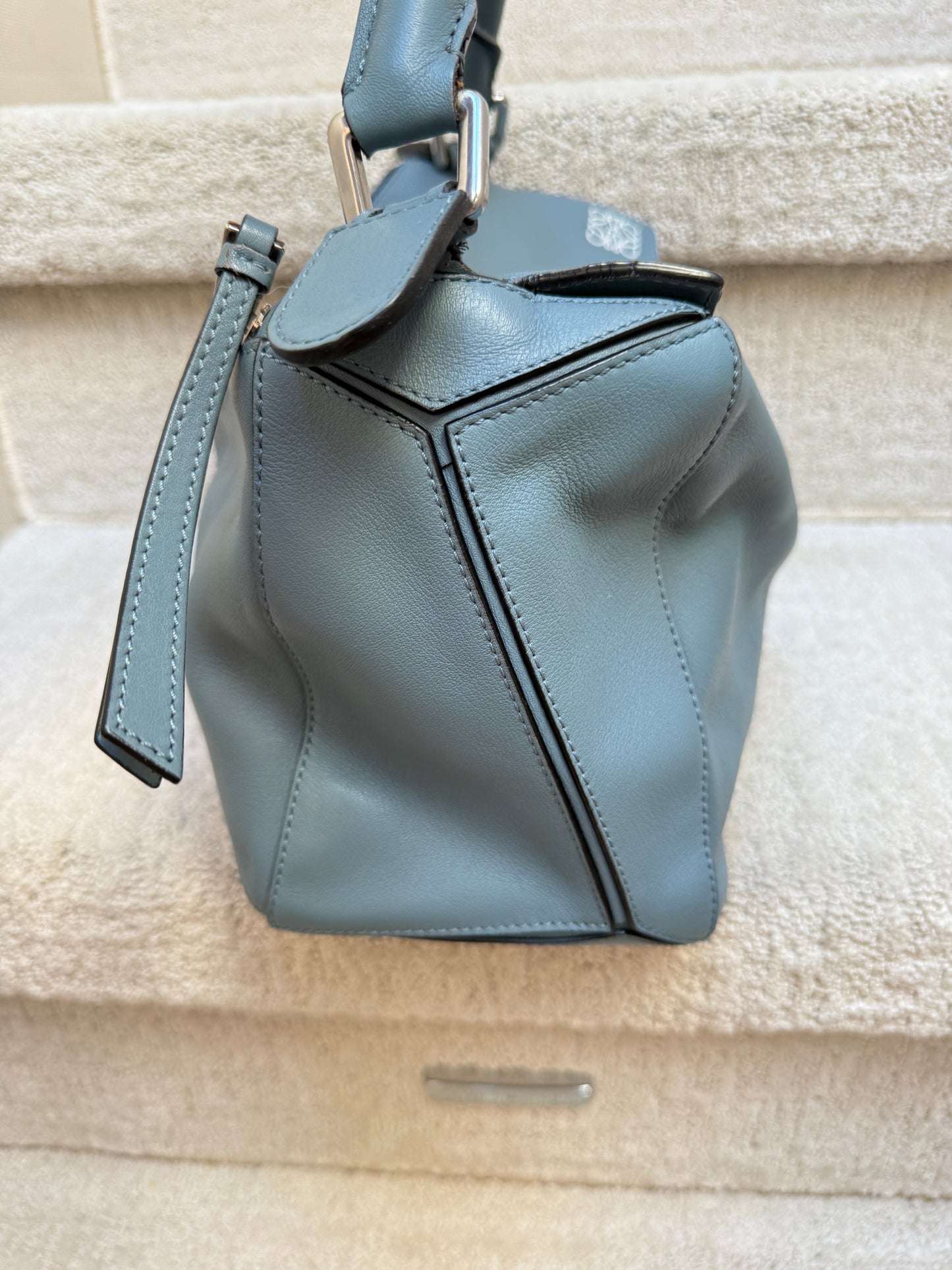 Side photo of loewe handbag in blue leather with silver hardware