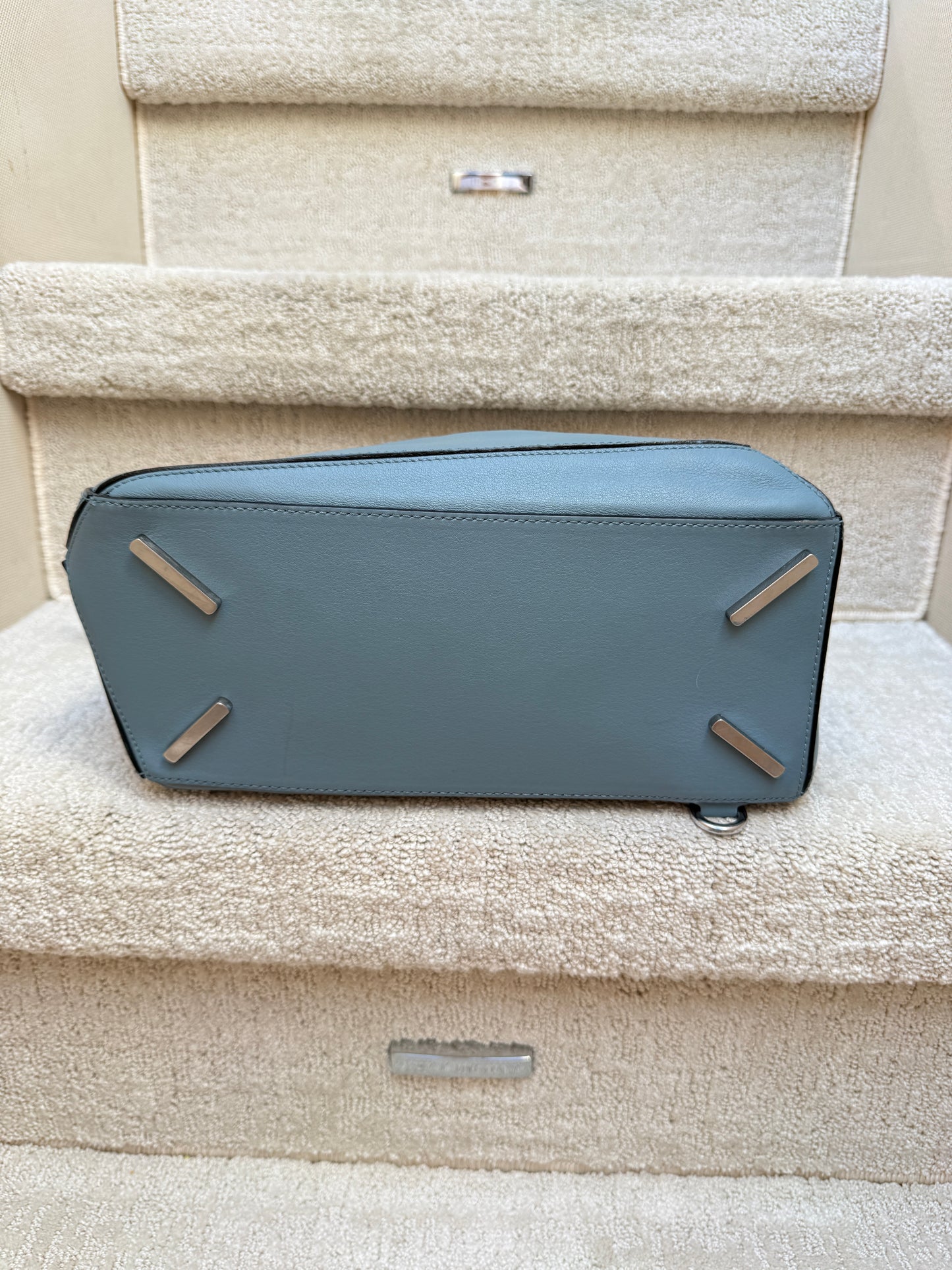 shows bottom of handbag from loewe with silver feet