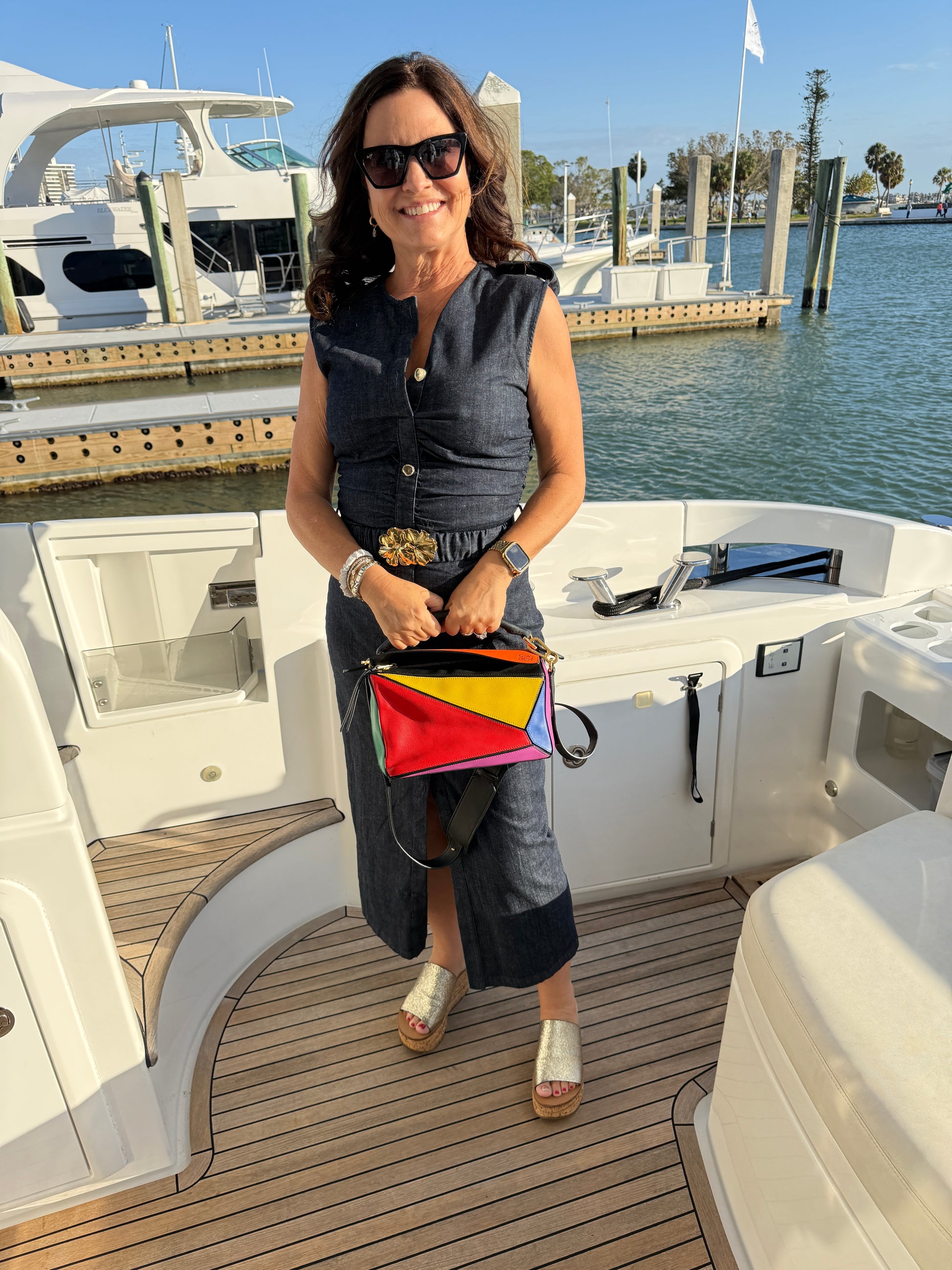 Loewe puzzle bag in size small shown carried by top handle by a woman