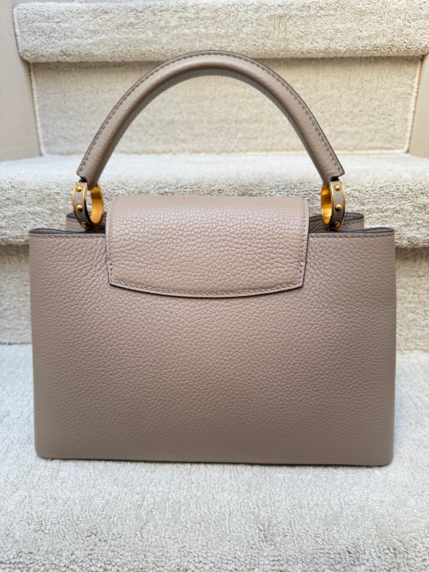 Louis Vuitton Taurillon Capucines PM in Galet or taupe