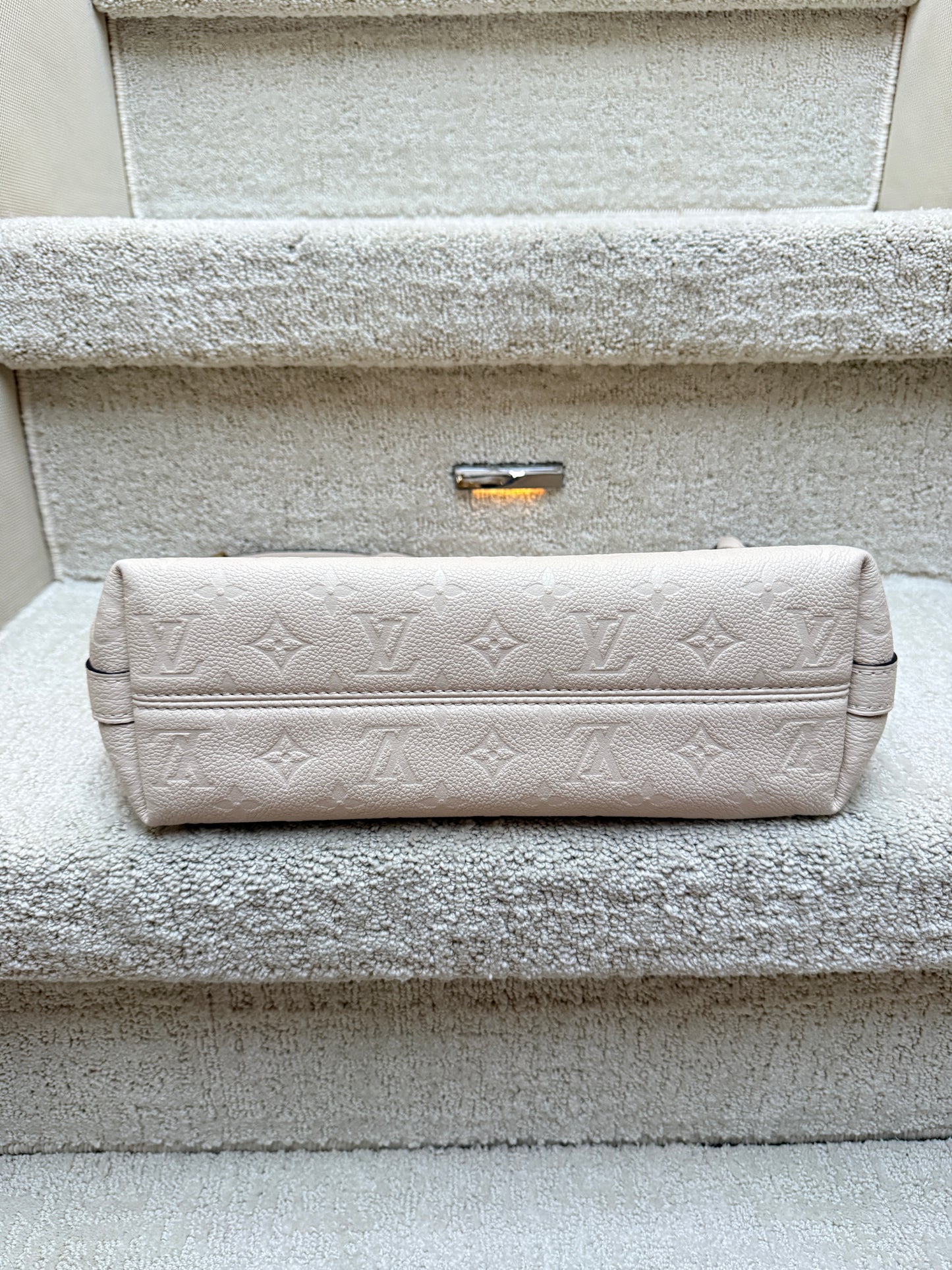 Louis Vuitton cream shoulder bag view of bottom of bag