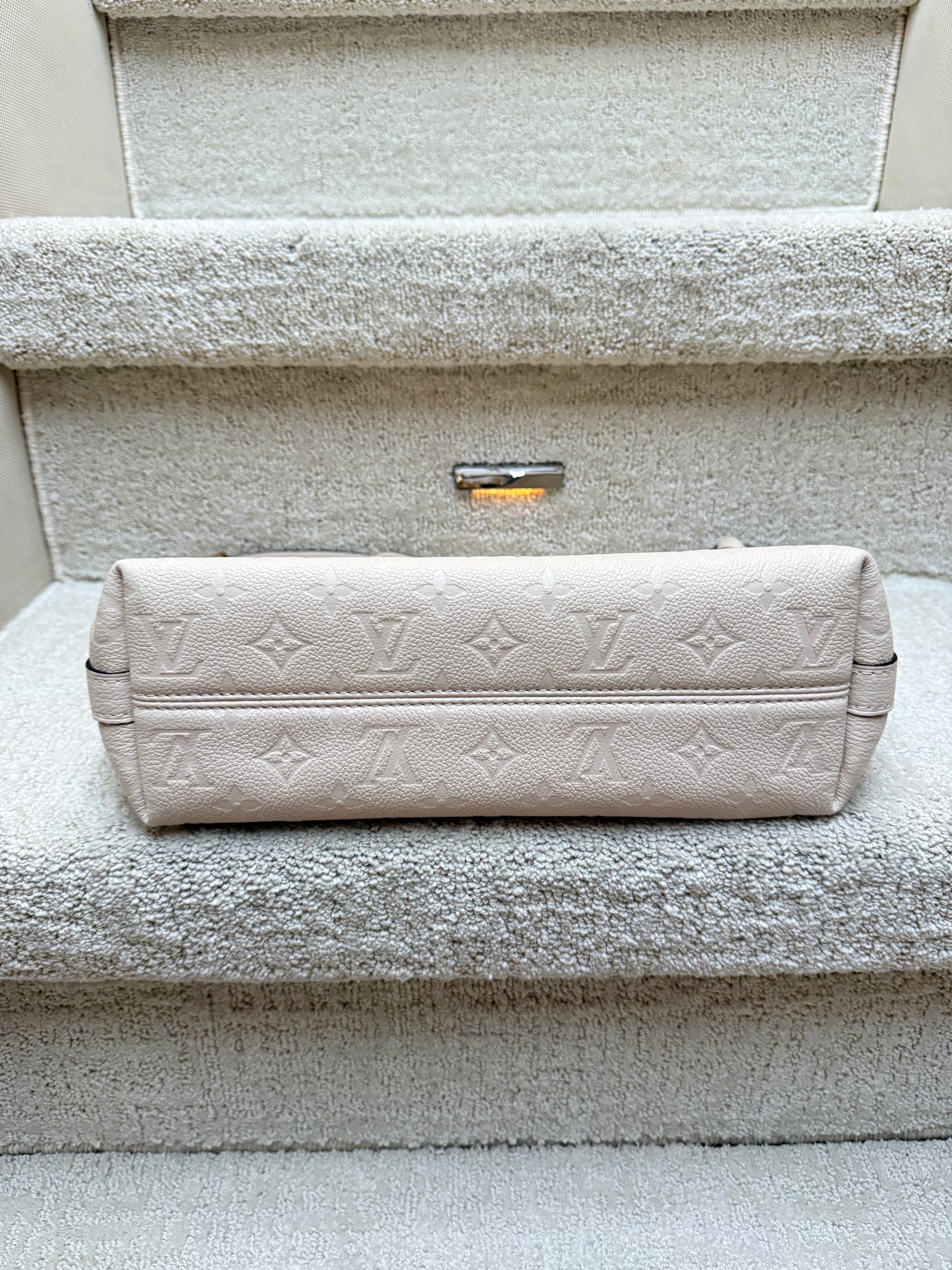 Louis Vuitton cream shoulder bag view of bottom of bag