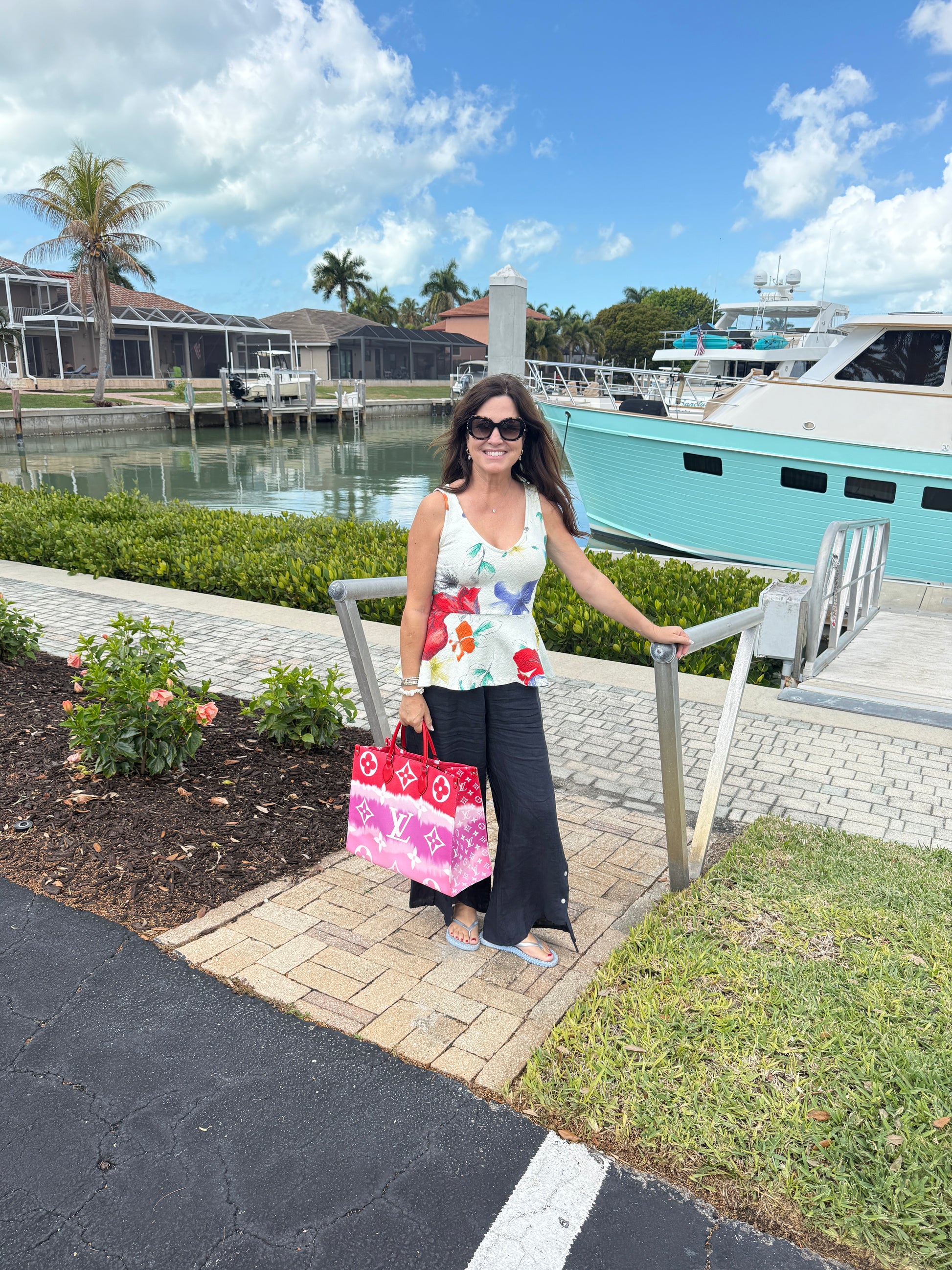 woman holding louis vuitton on the go in gm size in red and pink preloved