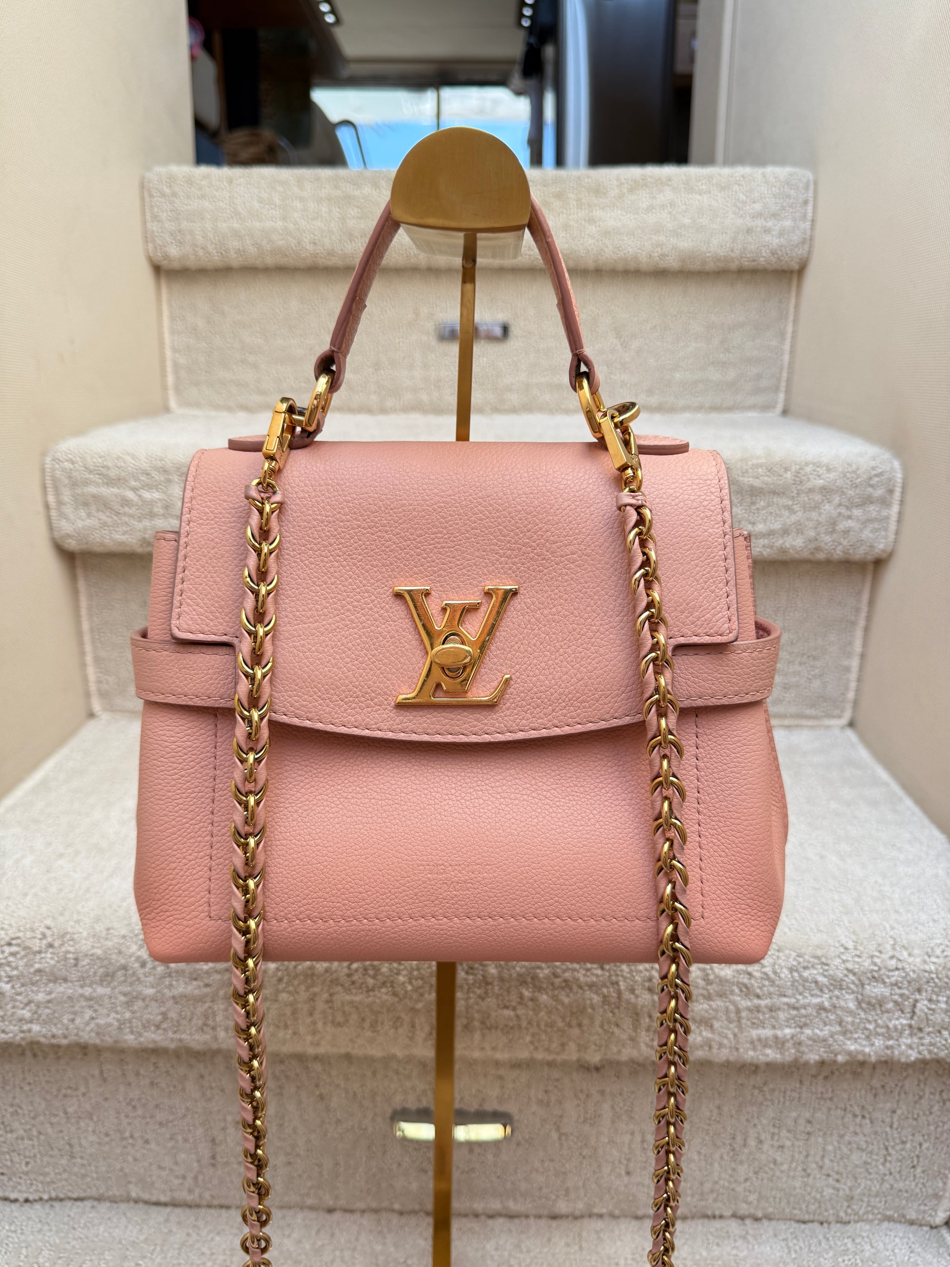 Close up of louis vuitton lockmeever purse twist lock with threaded chain strap and top handle for sale