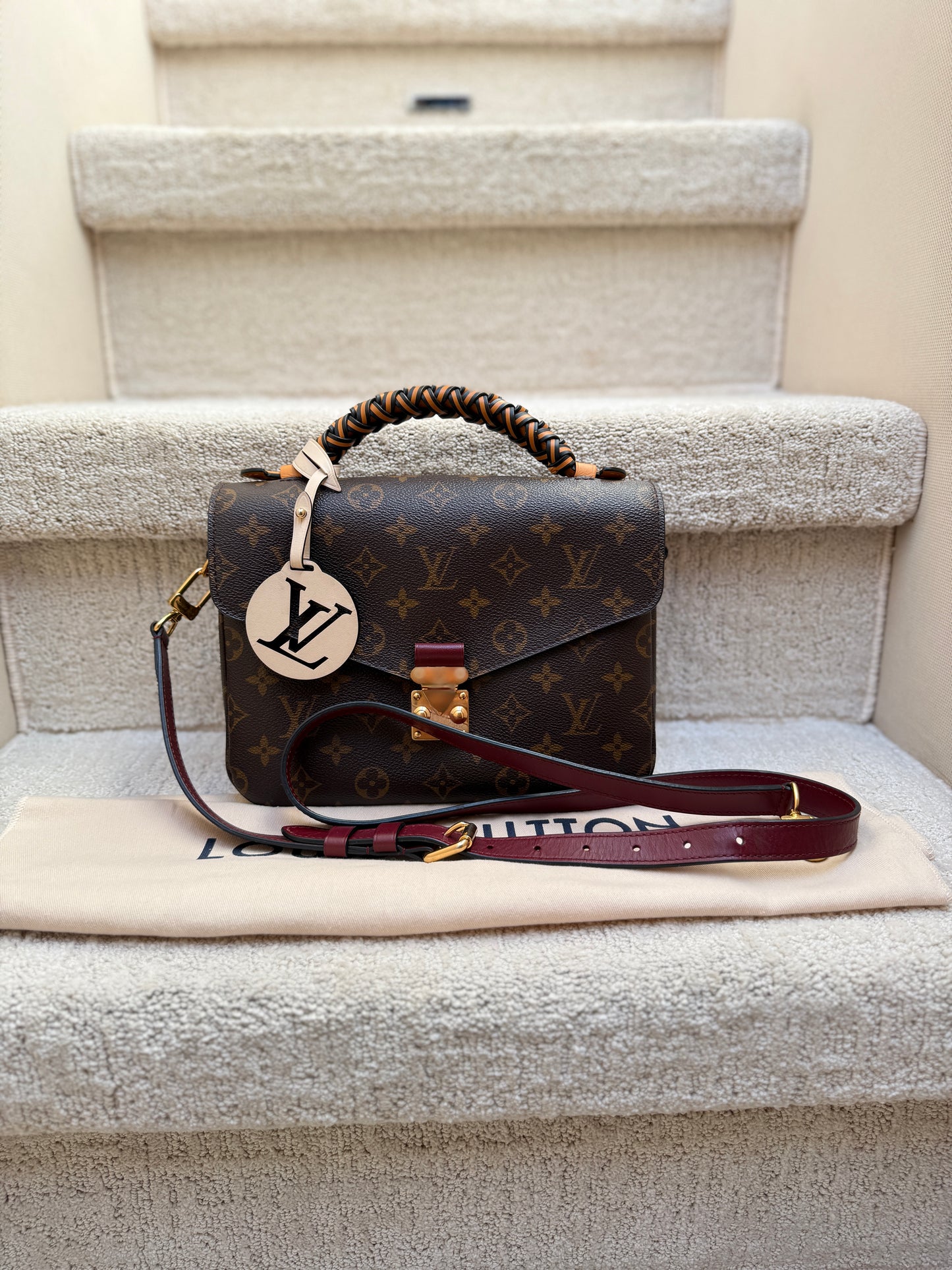 Louis Vuitton Pochette Metis in Monogram with braided top handle, special LV bag charm and burgundy leather adjustable shoulder strap authentic and preowned for sale from purseonalshopper