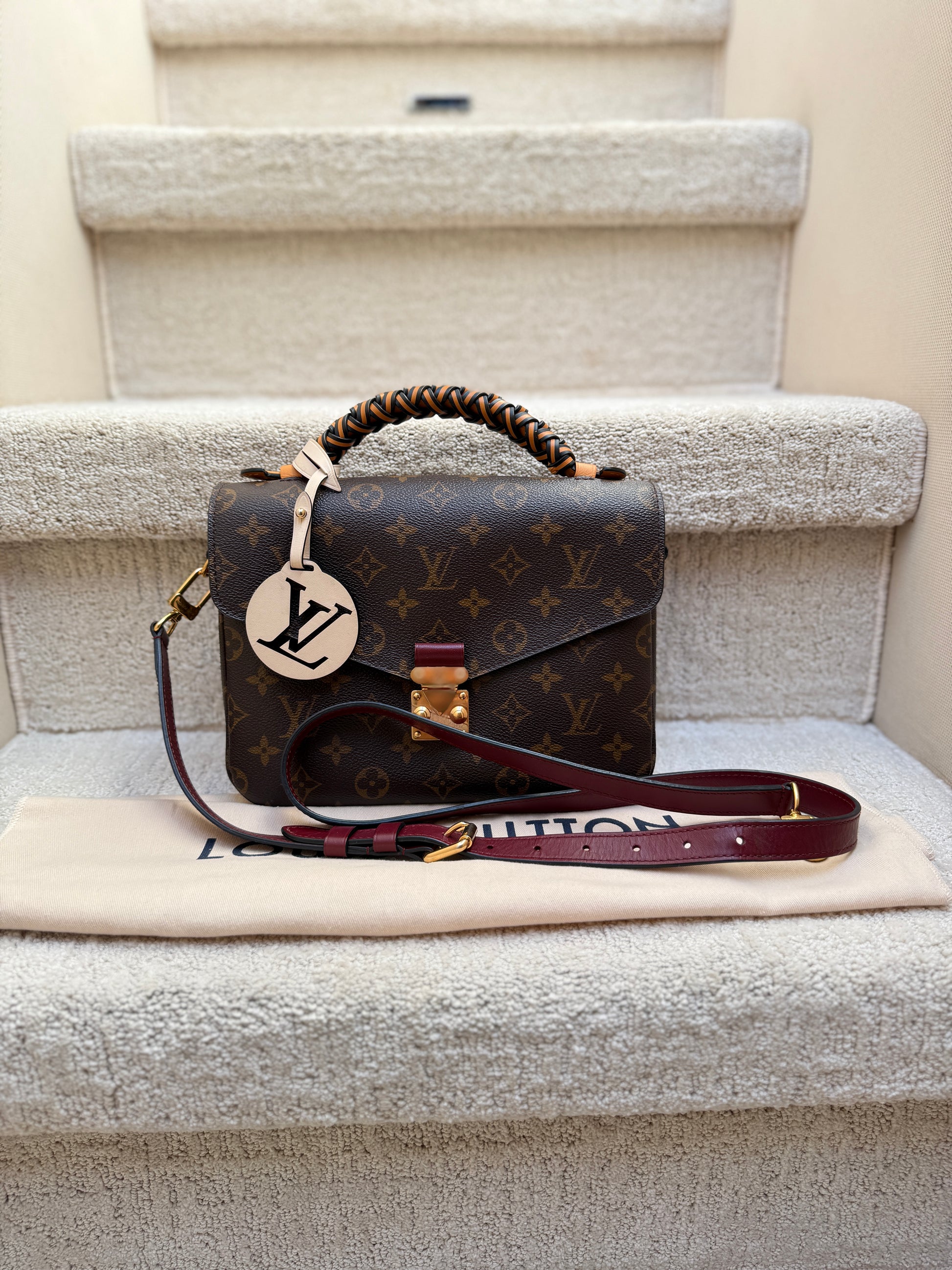 Louis Vuitton Pochette Metis in Monogram with braided top handle, special LV bag charm and burgundy leather adjustable shoulder strap authentic and preowned for sale from purseonalshopper