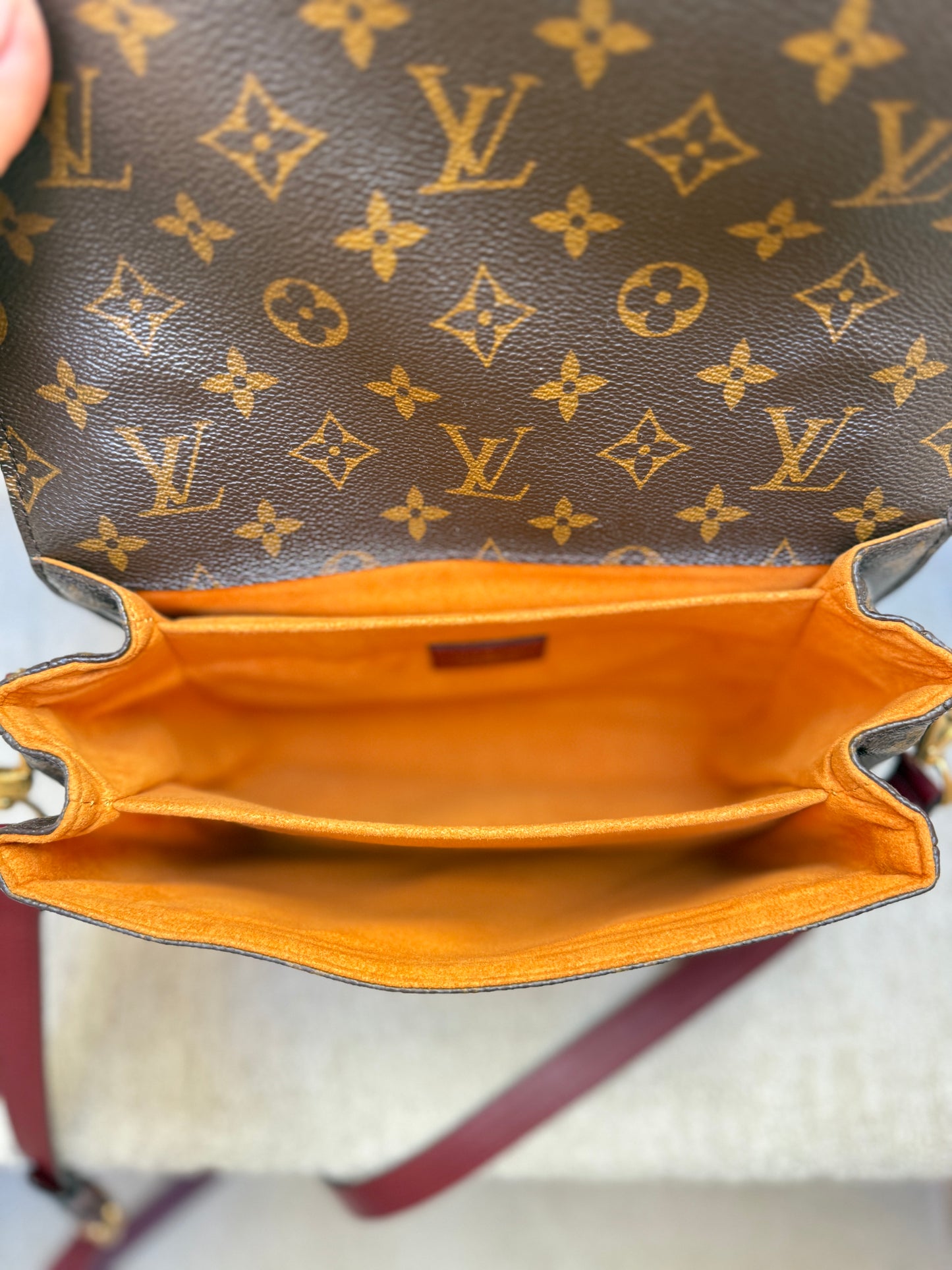View of orange interior on authentic preloved louis vuitton pochette metis from purseonalshopper