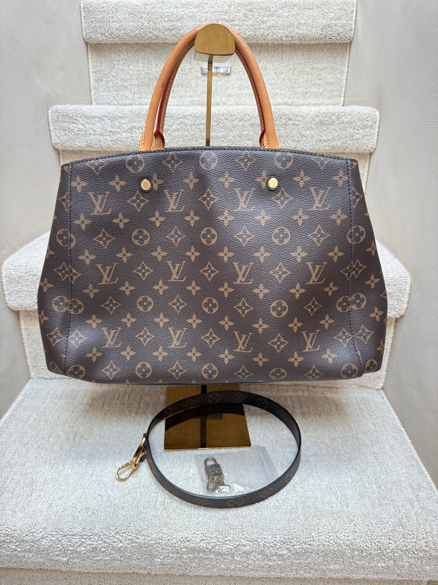 Louis Vuitton Montaigne GM Monogram canvas front view With lock, key and shoulder strap
