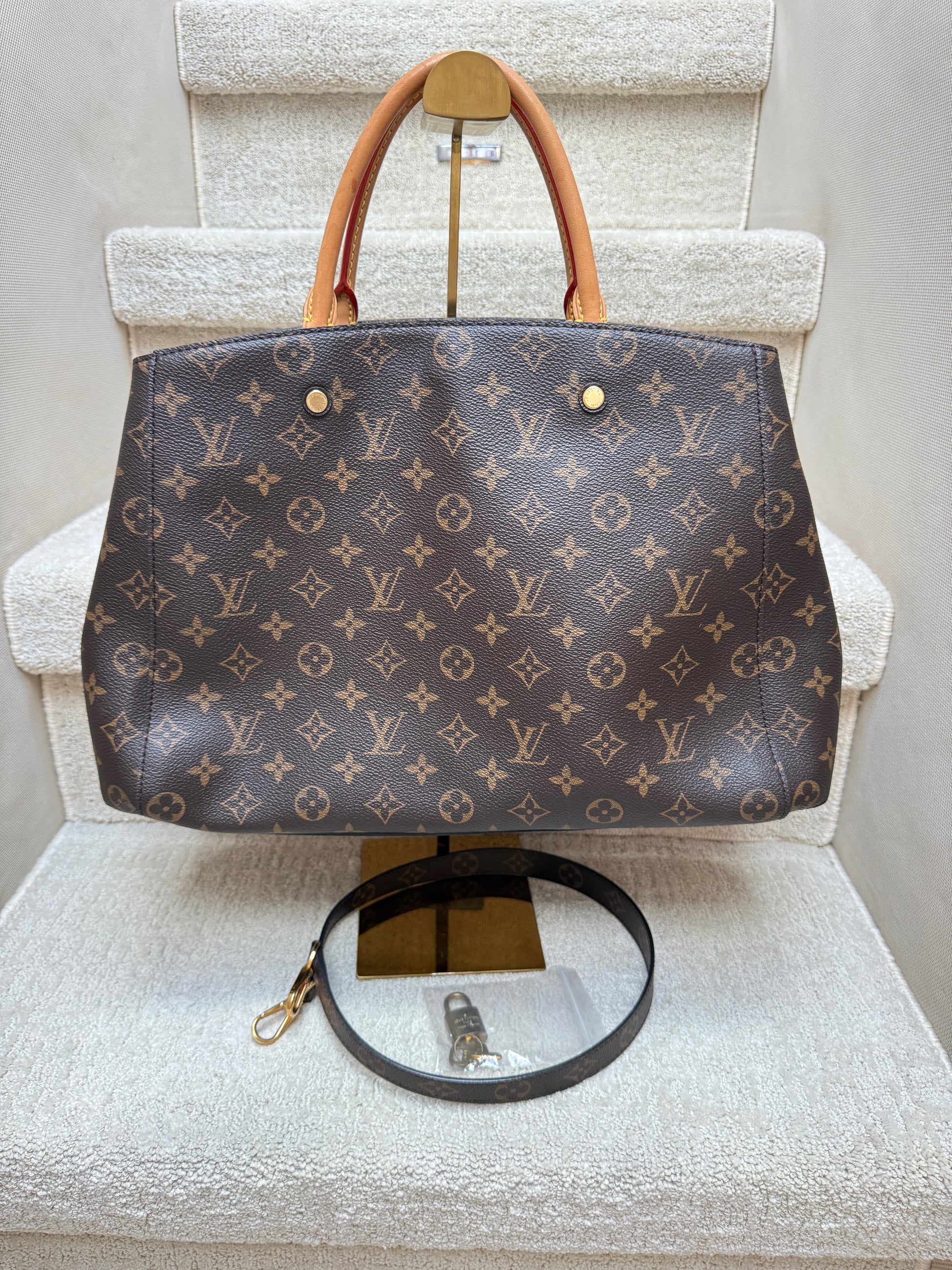 Louis Vuitton Montaigne GM Monogram canvas front view With lock, key and shoulder strap