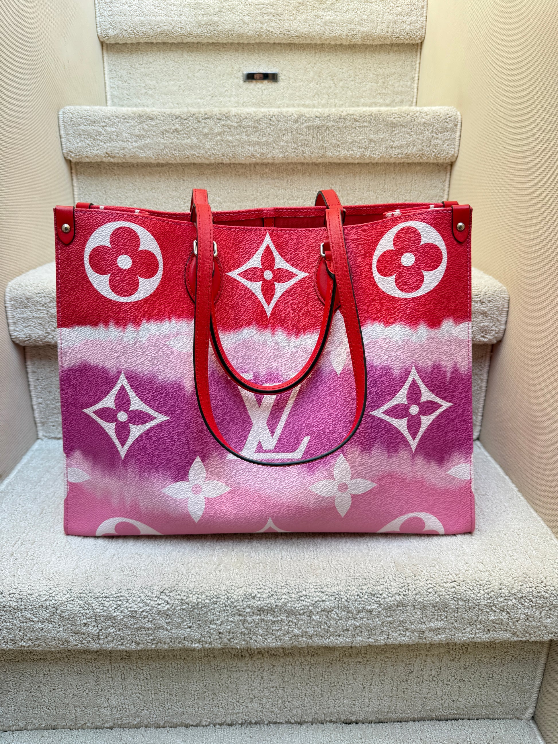 louis vuitton onthego gm size in red, pink and purple coated canvas with double handles authentic and preowned from purseonalshopper
