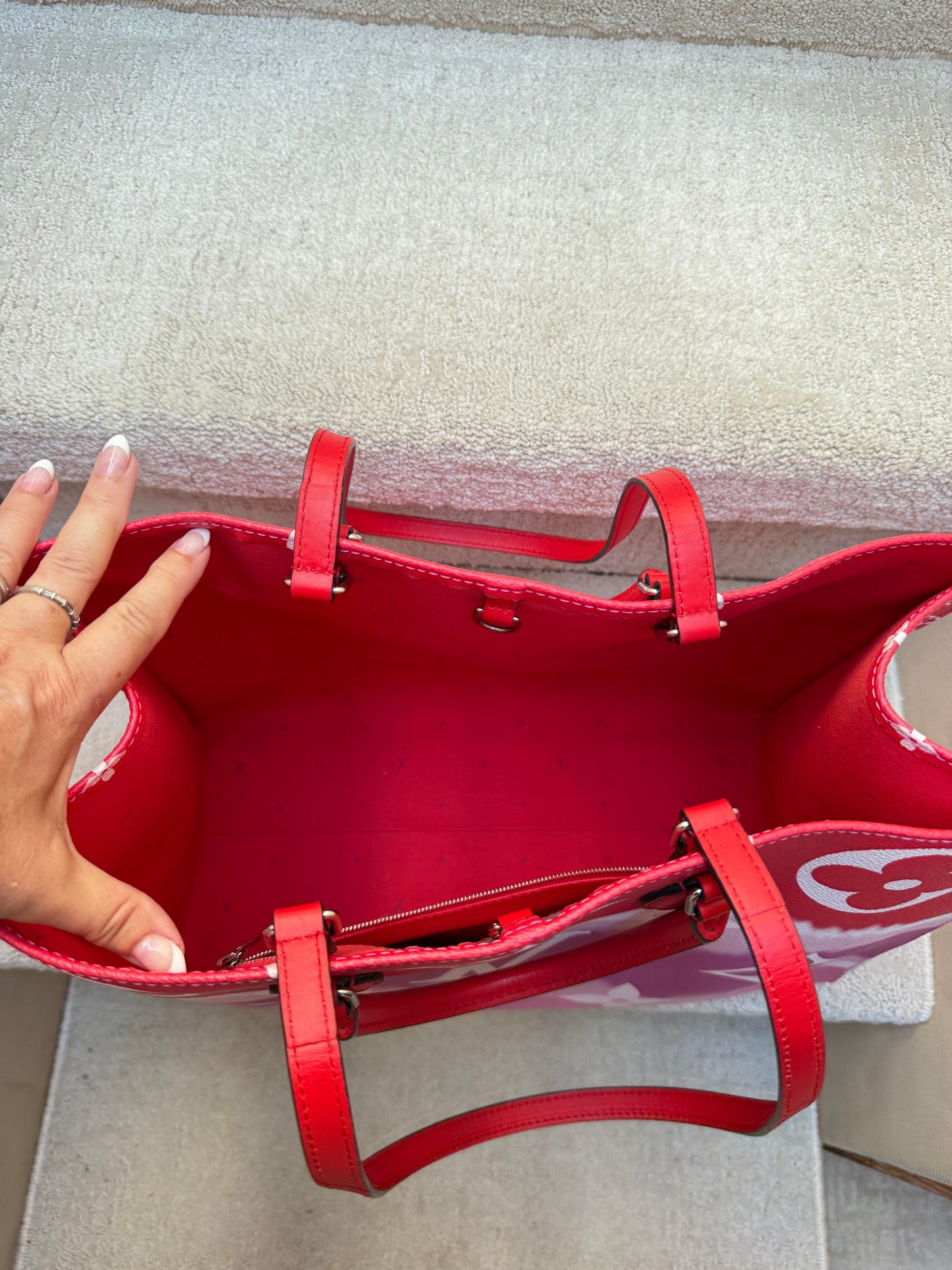interior of louis vuitton on the go tote in red clean and spotless
