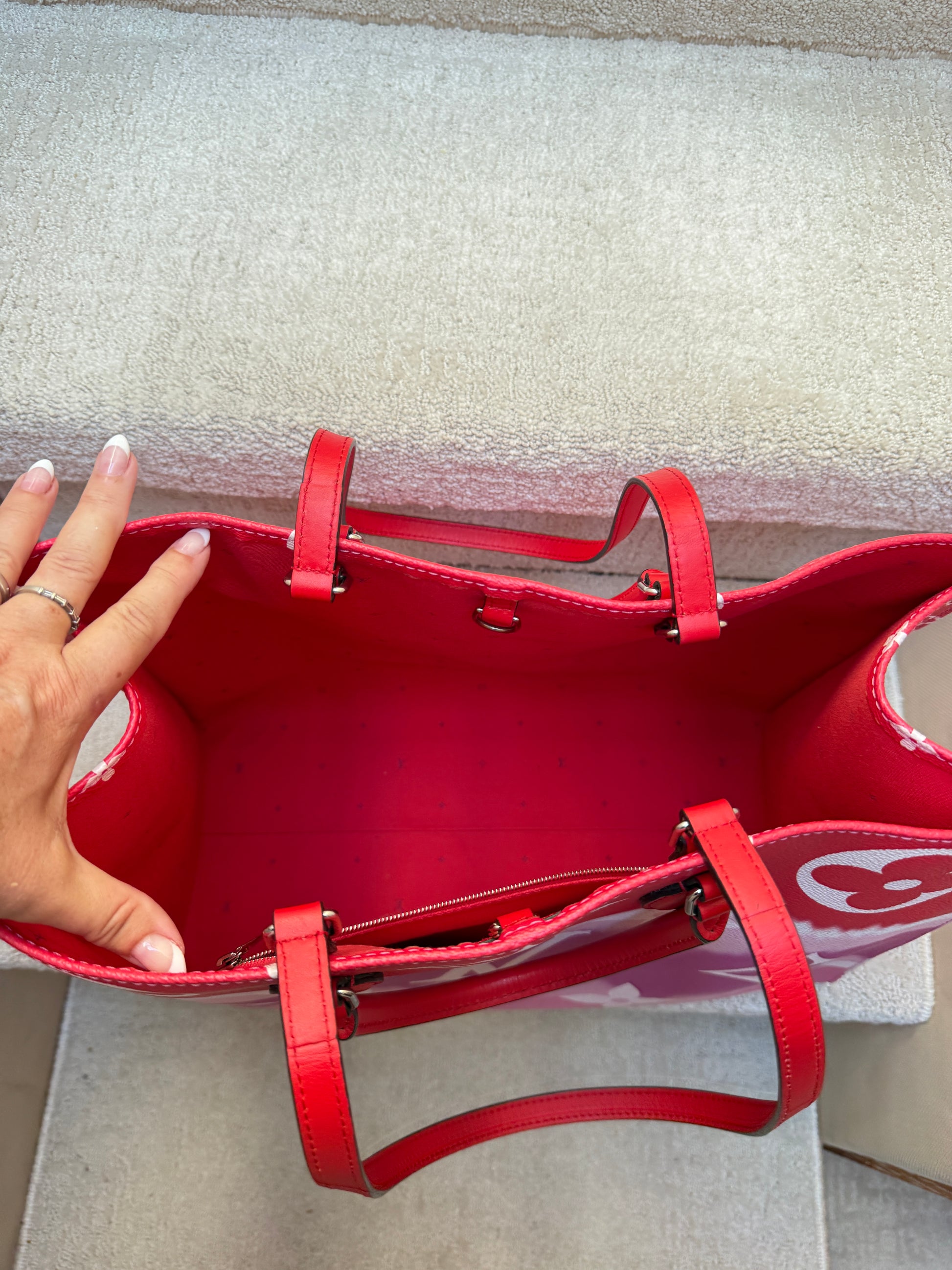 interior of louis vuitton on the go tote in red clean and spotless
