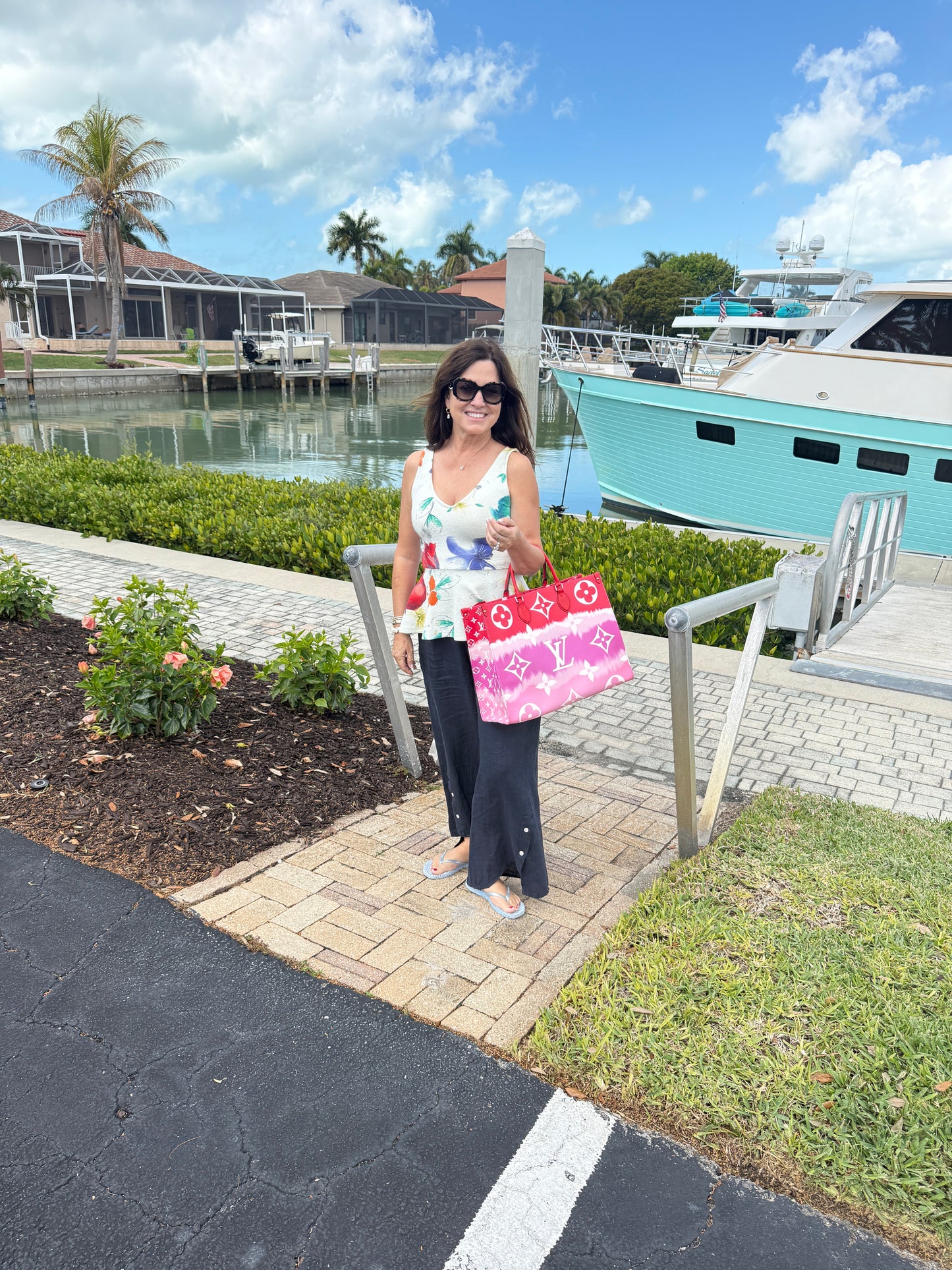 Louis Vuitton on the go shown on woman on crook of arm resale consignment 