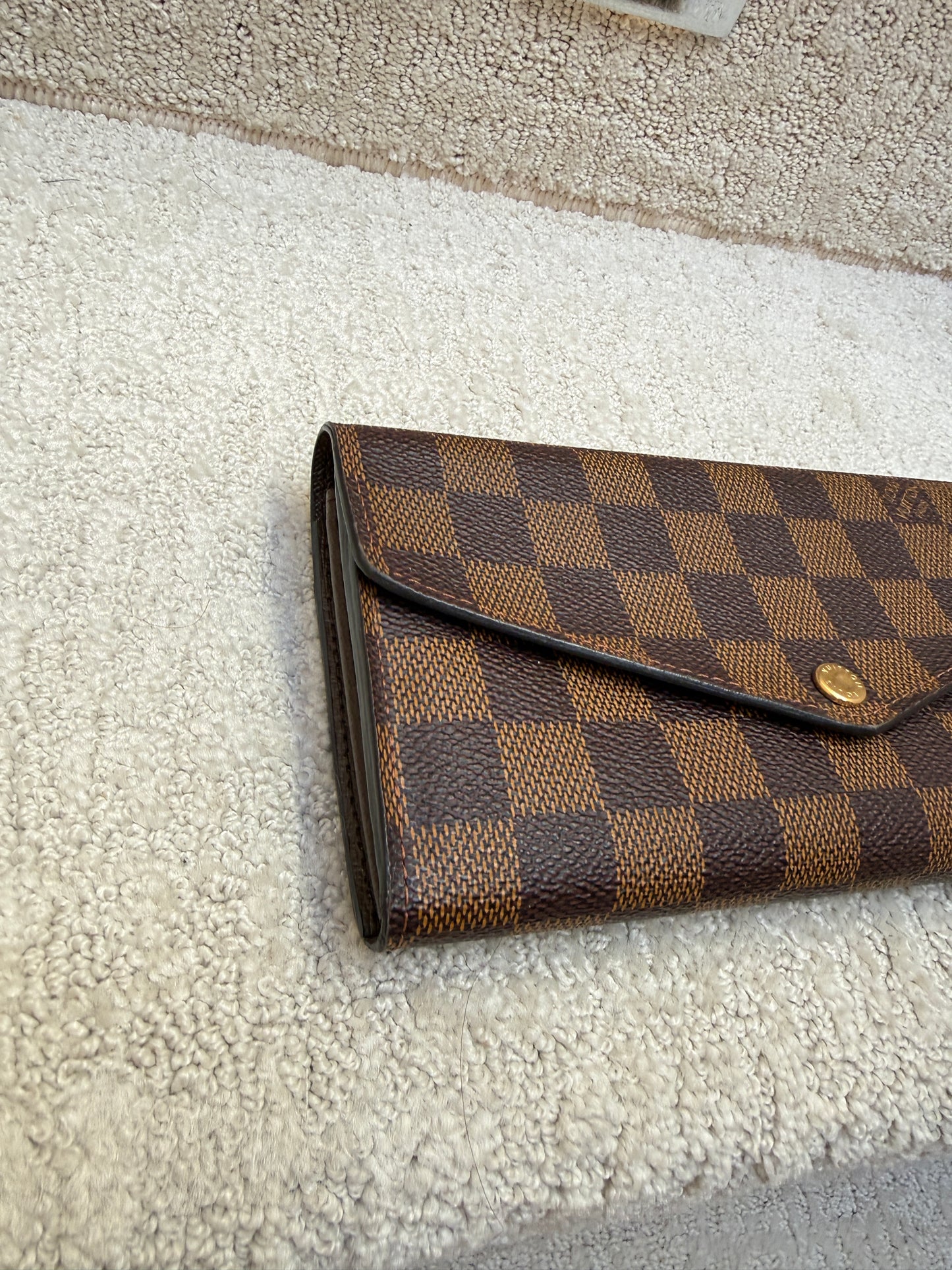 side view of louis vuitton sarah wallet in excellent condition resale consignment