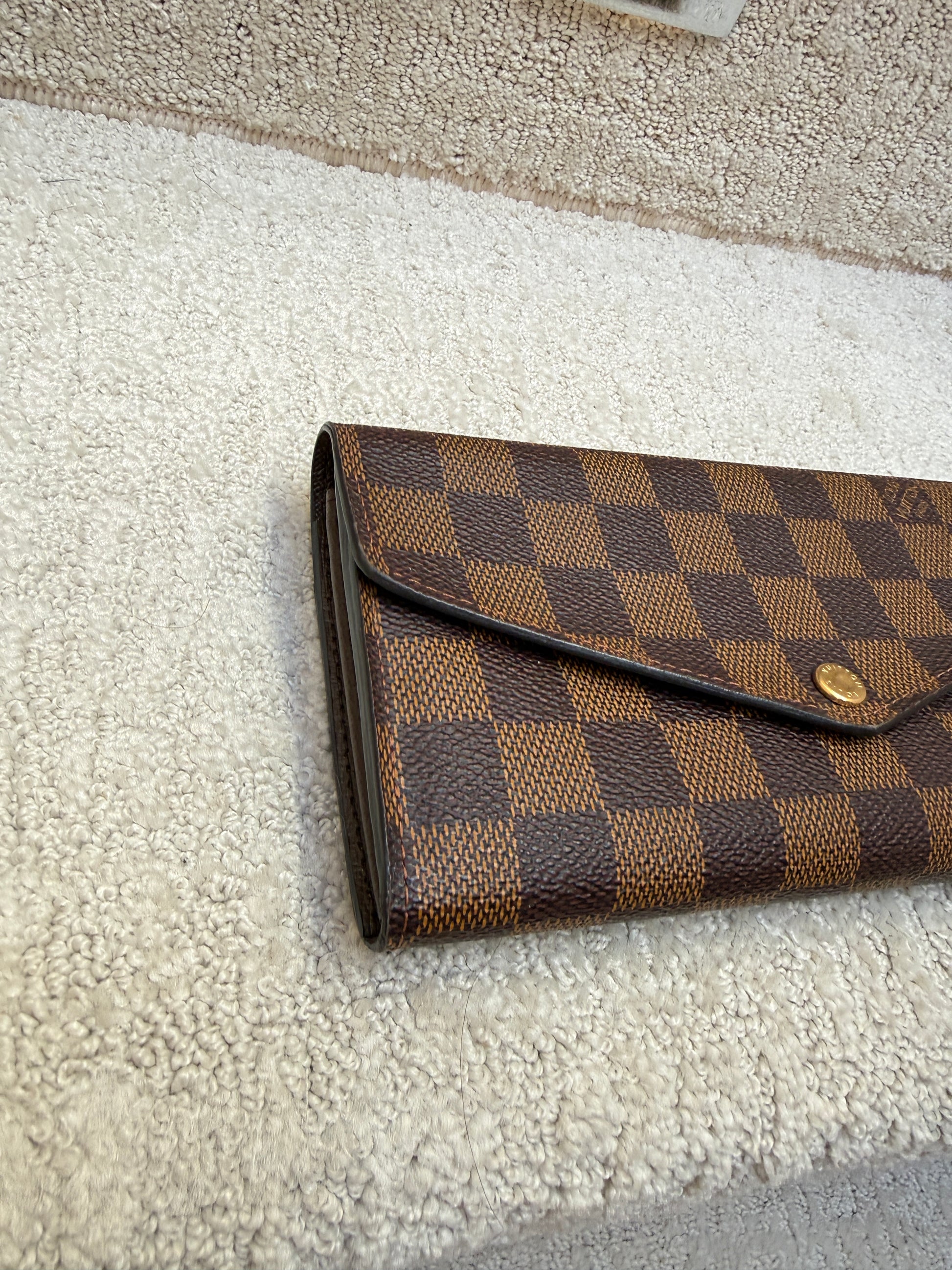 side view of louis vuitton sarah wallet in excellent condition resale consignment