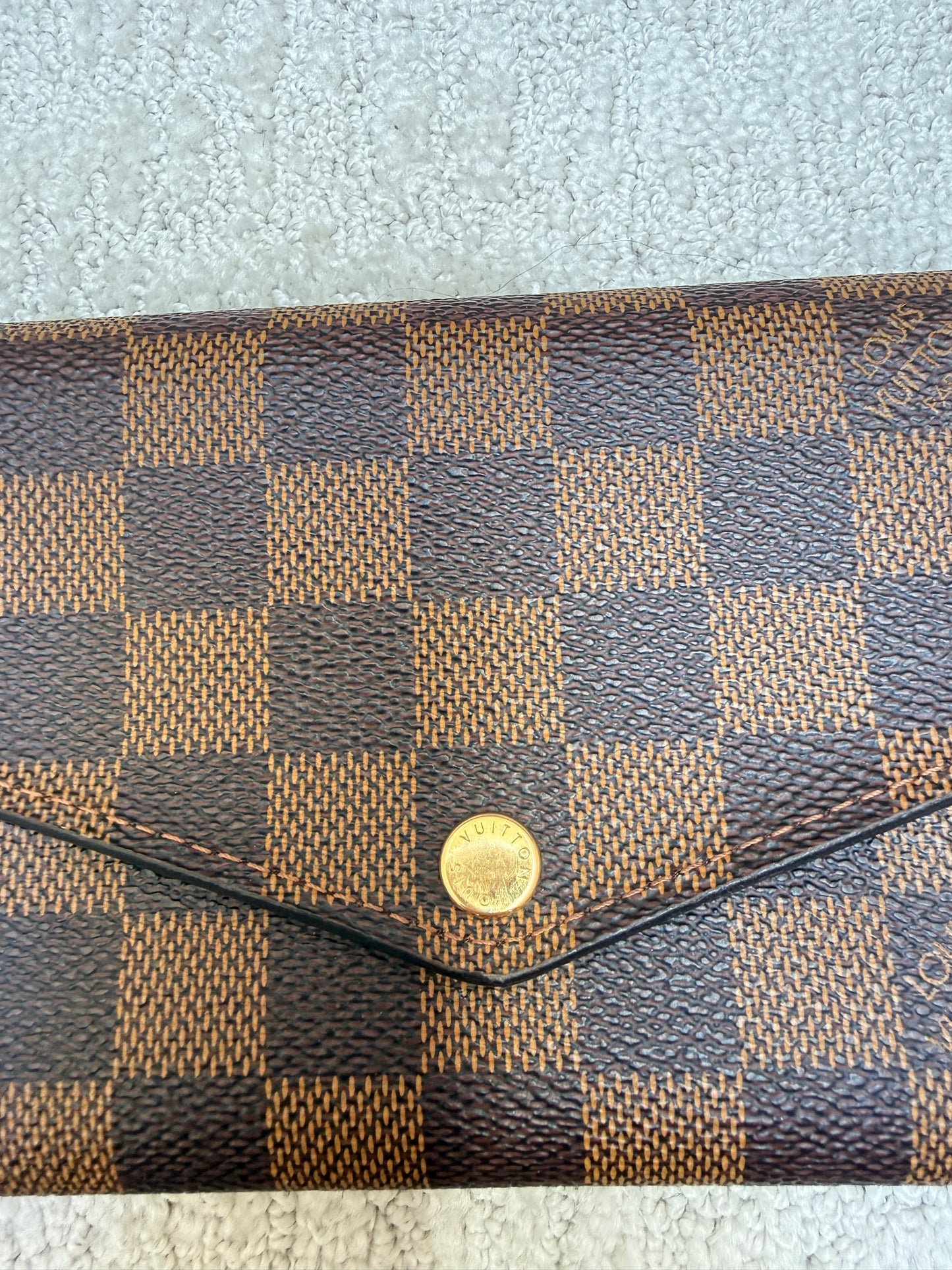 louis vuitton sarah wallet closeup of gold hardware no tarnish