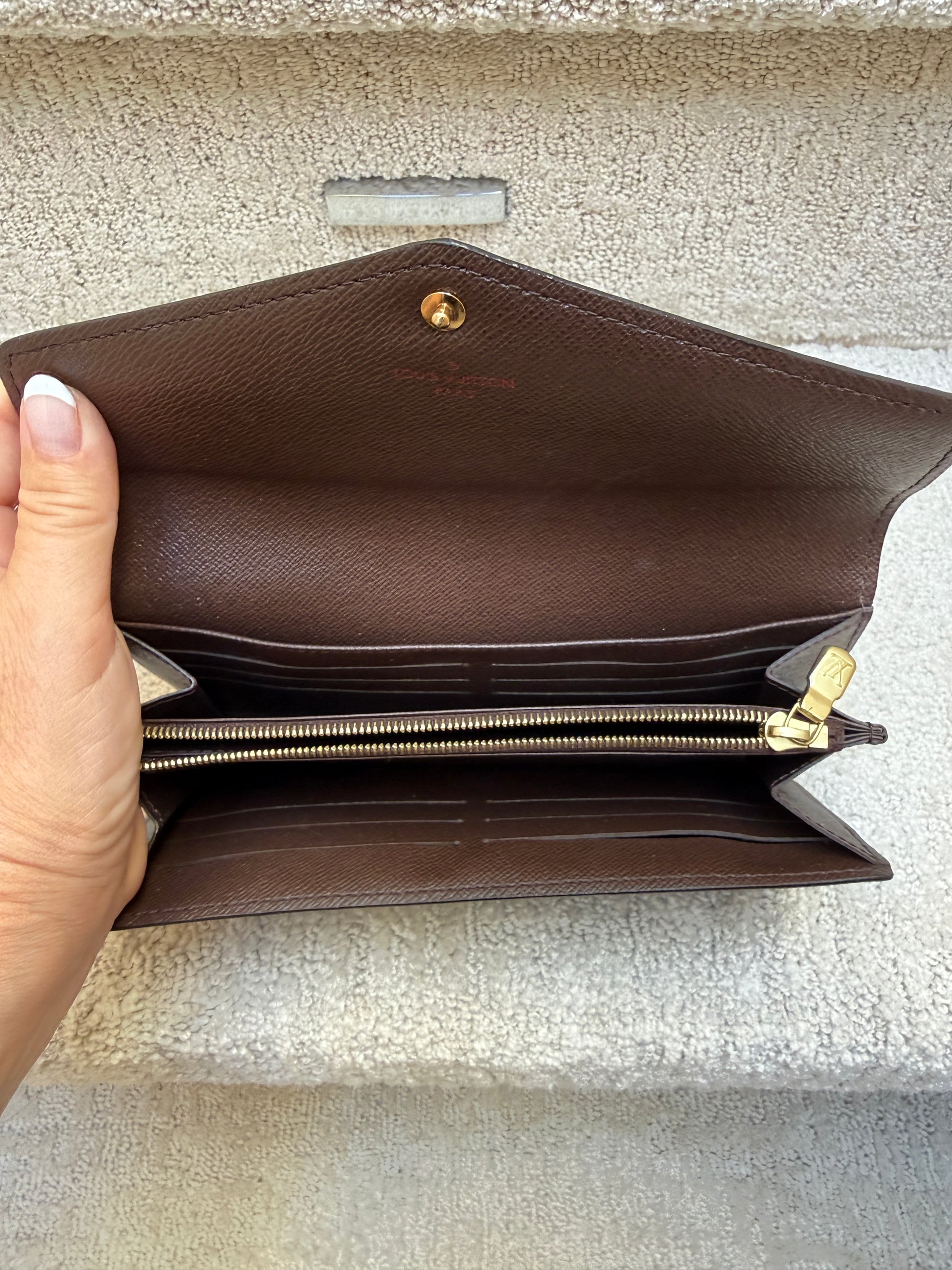 Louis Vuitton Sarah Wallet showing clean interior photo