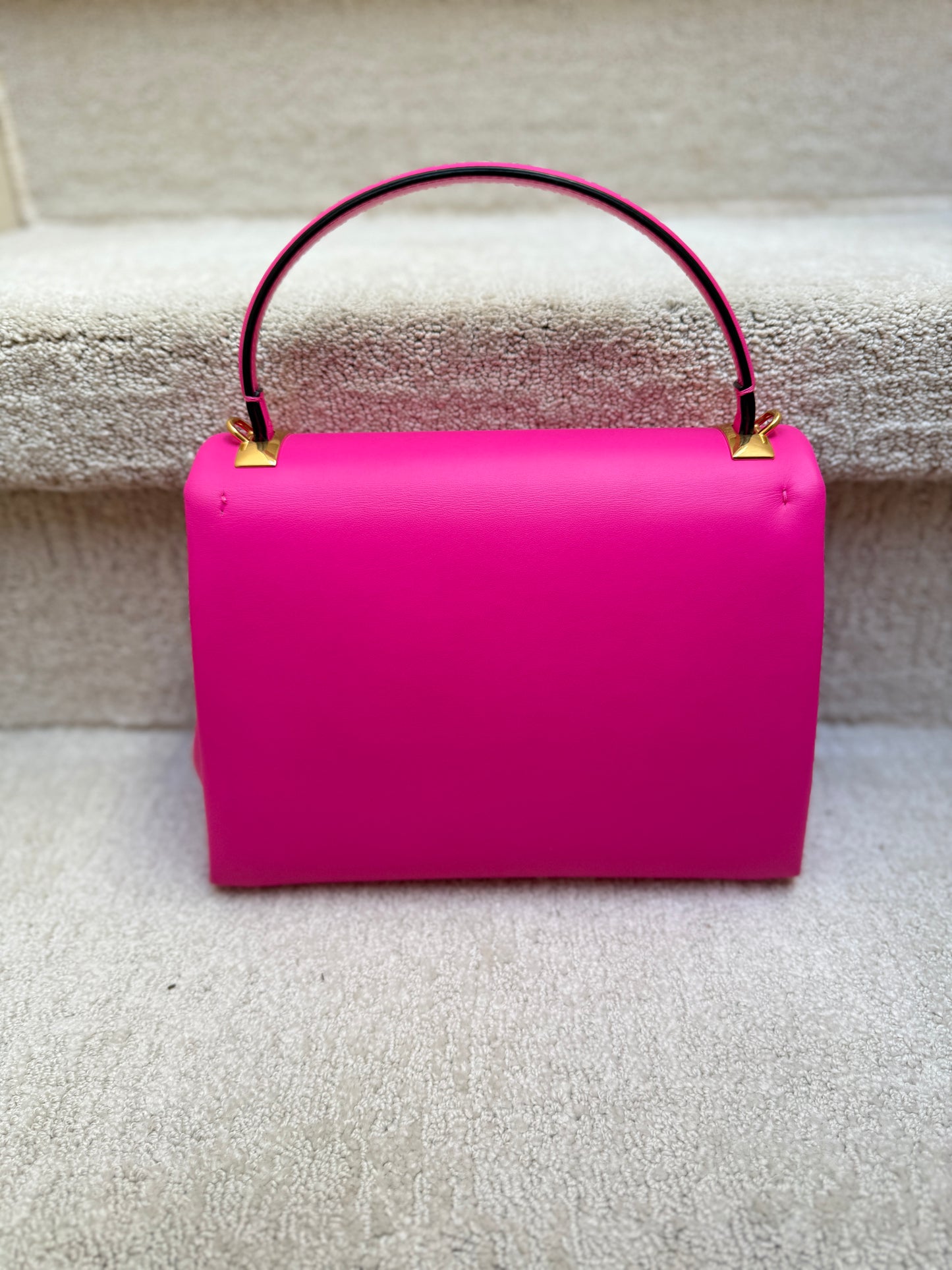 Back side view of valentino purse with gold studs in excellent used condition